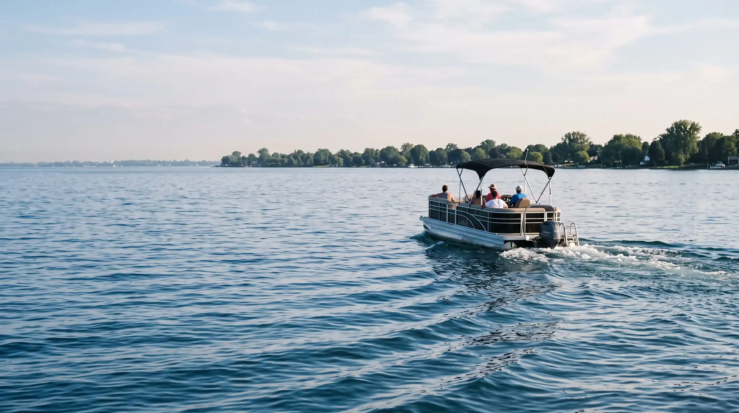 Pontoon boat cruising on Lake St. Clair on a calm summer afternoon